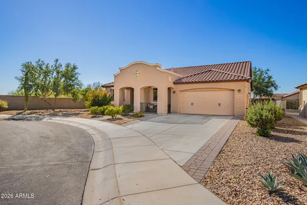 a view of a house with a yard and a garage