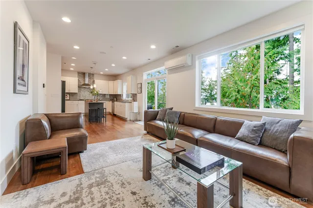 a kitchen with kitchen island granite countertop a sink a counter space appliances and cabinets