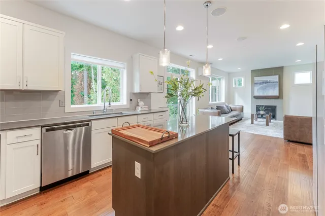 a kitchen with stainless steel appliances granite countertop a stove and a refrigerator