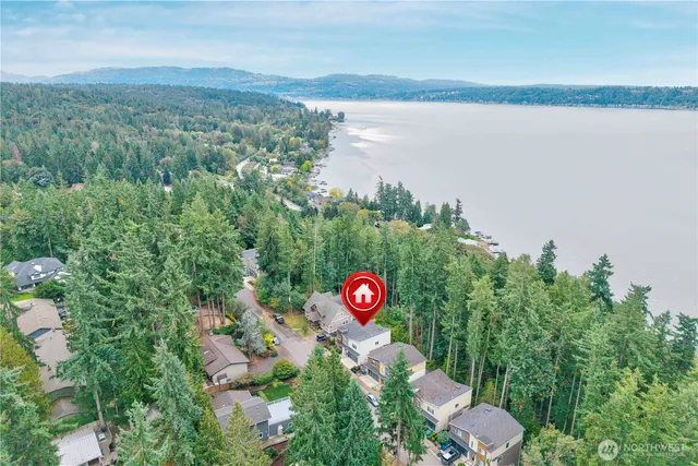 a man sitting on a bench in a backyard of a house