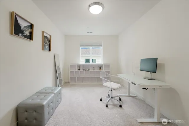 a bedroom with a bed and large windows