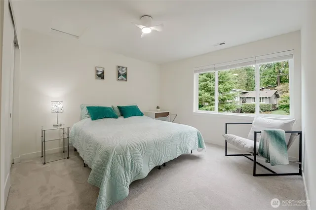 a bedroom with a bed and a window