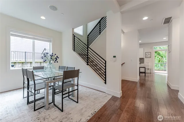 a living room with wooden floor and furniture