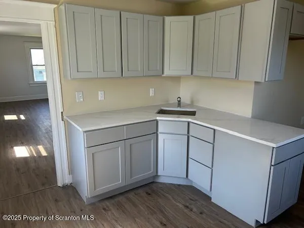 a kitchen with white cabinets