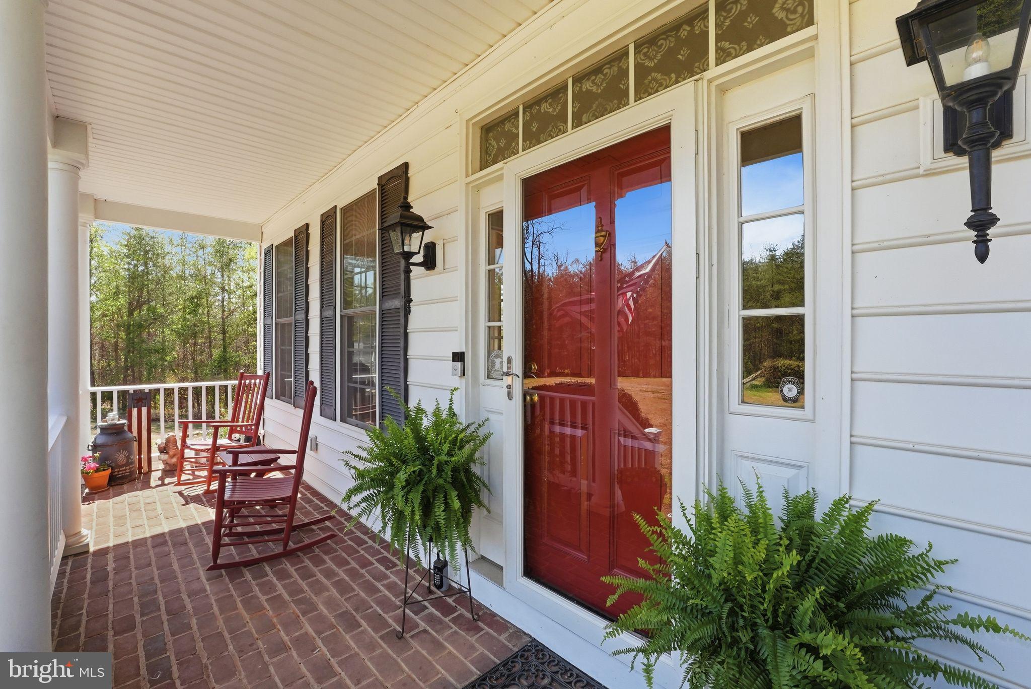 140 Woods Ridge Lane Reva, VA 22735 - Photo 3 of 87 a view of a balcony with chairs and wooden floor