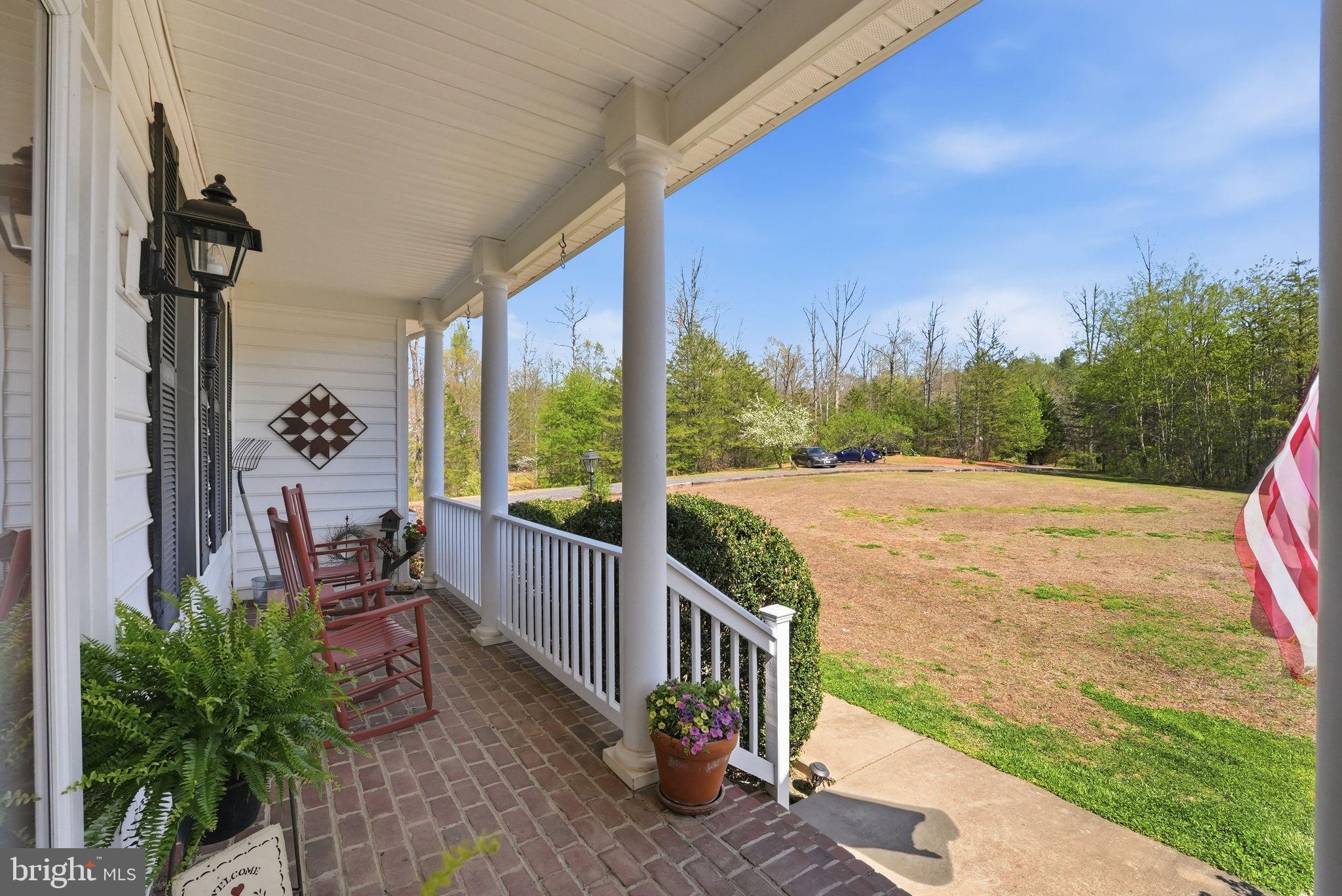 140 Woods Ridge Lane Reva, VA 22735 - Photo 49 of 87 a view of a patio with lawn chairs potted plants and wooden fence
