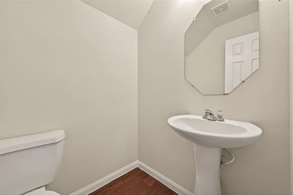 a bathroom with a sink a mirror and a toilet