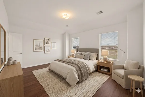 a bedroom with a large bed and a couch