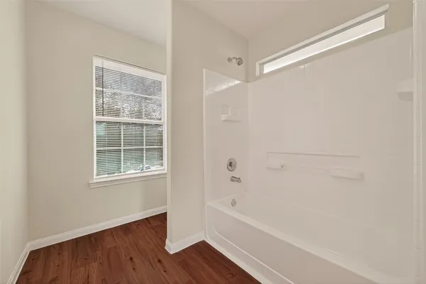 a bathroom with bathtub and shower