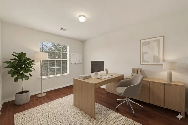 a view of a workspace with furniture and a potted plant