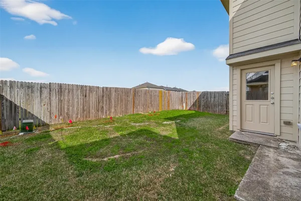 a view of an house with backyard space and garden