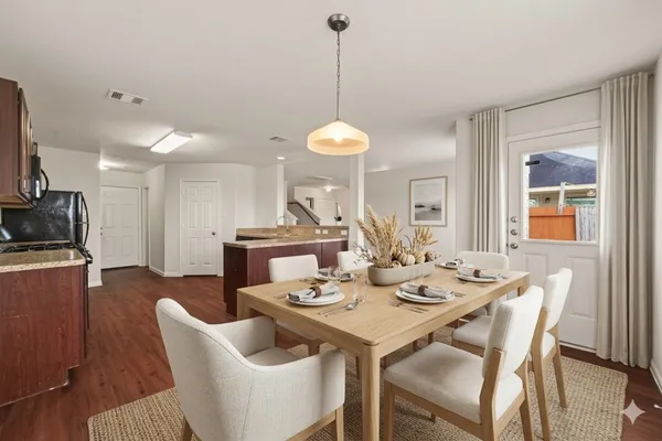 a dining room with furniture a chandelier and window