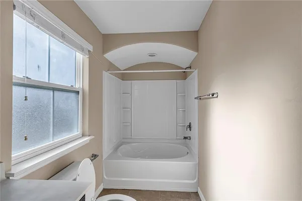 a bathroom with a tub and shower