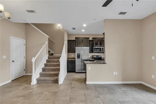 a view of a kitchen with a sink stove and a refrigerator