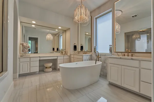 a large spacious bathroom with a double vanity sink a mirror and a