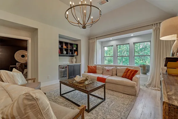 a living room with furniture a rug and a window