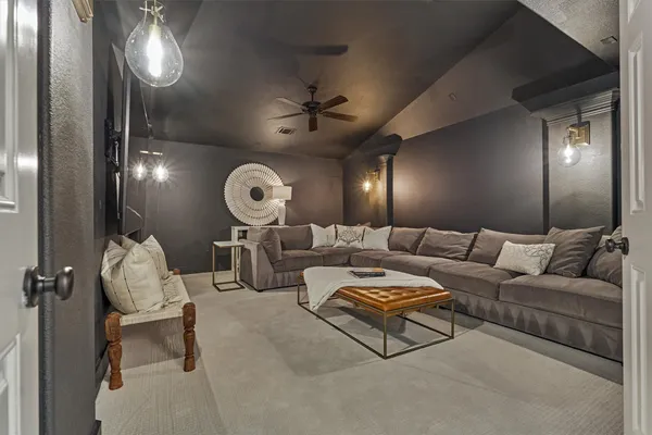 a living room with furniture a chandelier and a large window