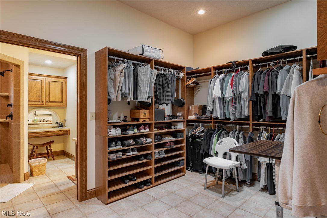 3908 River Road Vienna, WV 26105 - Photo 25 of 48 Master closet is 10x16 with ceramic floors, built-in ironing board, and plenty of storage space and cabinets