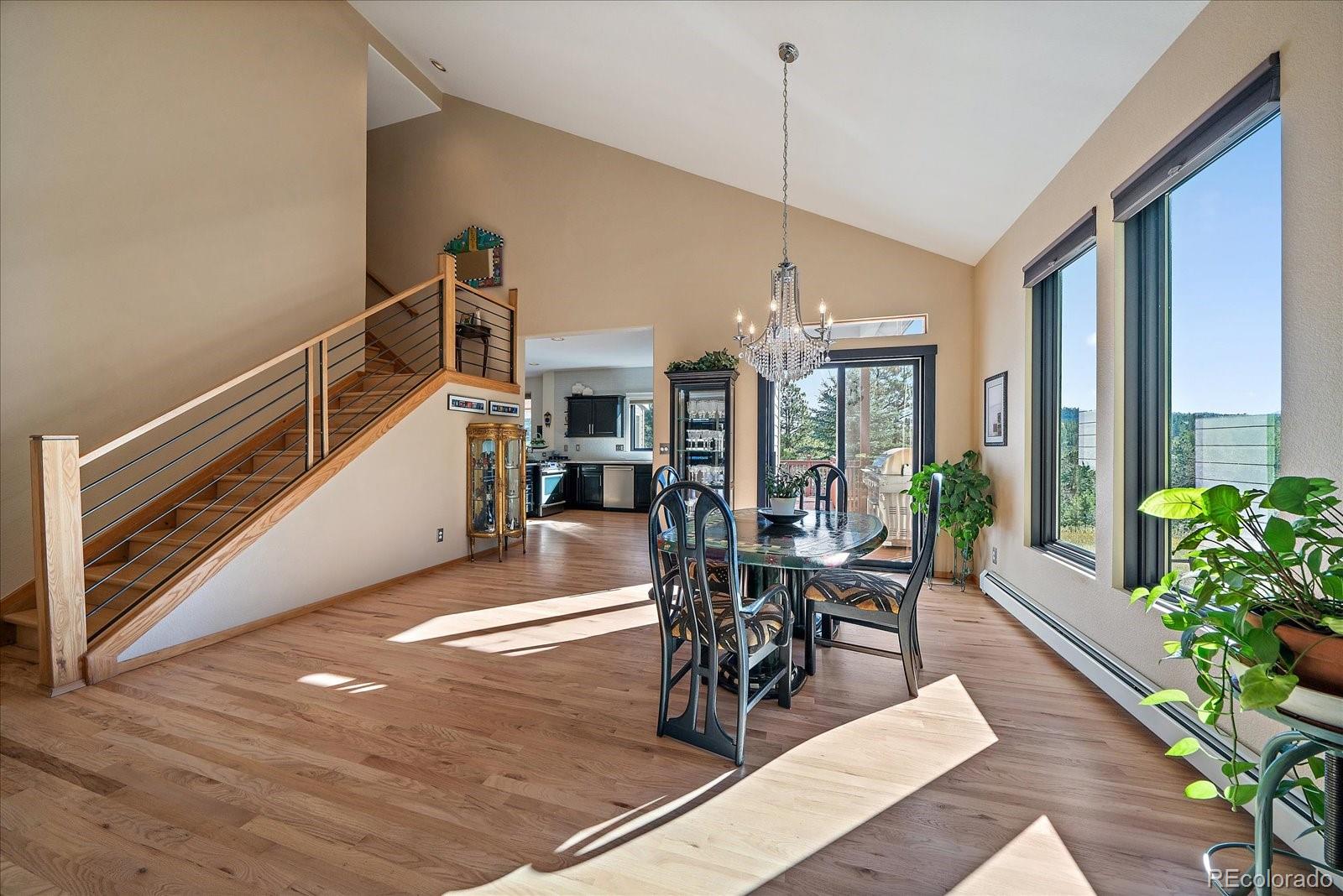 31518 Niakwa Road Evergreen, CO 80439 - Photo 11 of 48 a view of a dining room with furniture window and wooden floor