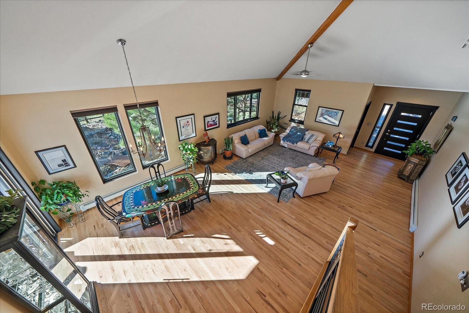 31518 Niakwa Road Evergreen, CO 80439 - Photo 17 of 48 a view of a livingroom with furniture hardwood floor and workspace