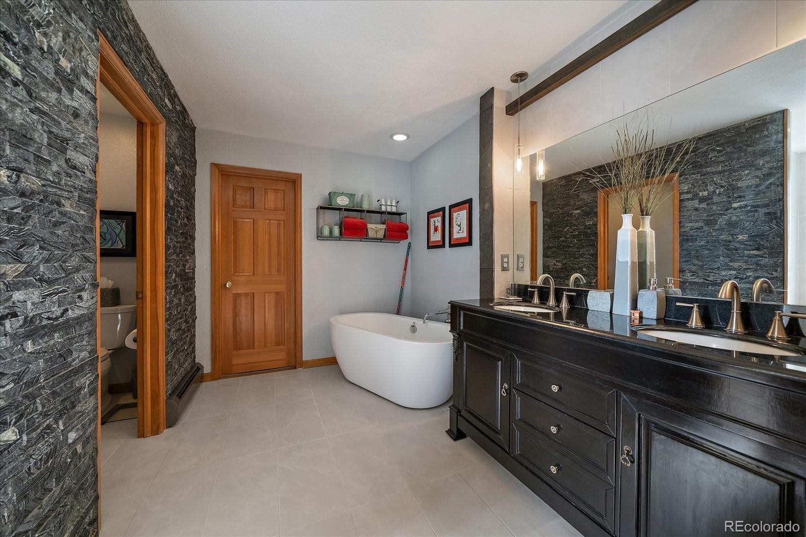 31518 Niakwa Road Evergreen, CO 80439 - Photo 20 of 48 a living room with furniture and a window