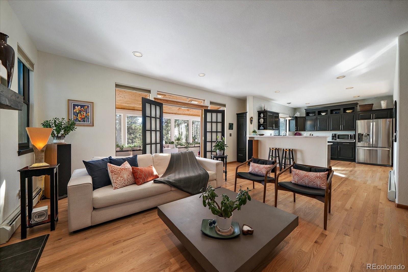 31518 Niakwa Road Evergreen, CO 80439 - Photo 2 of 48 a living room with furniture and a wooden floor