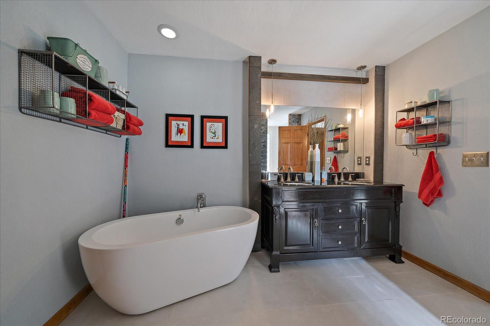 31518 Niakwa Road Evergreen, CO 80439 - Photo 21 of 48 a bathroom with a bathtub and a mirror