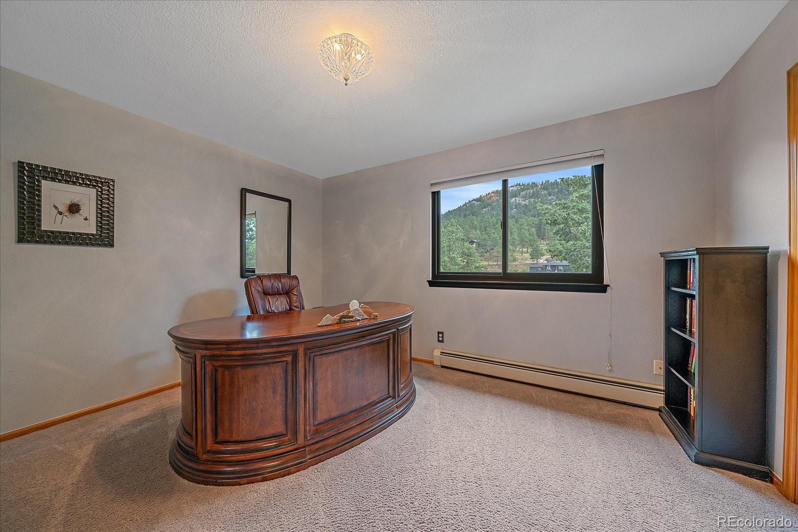 31518 Niakwa Road Evergreen, CO 80439 - Photo 23 of 48 a living room with furniture and a window