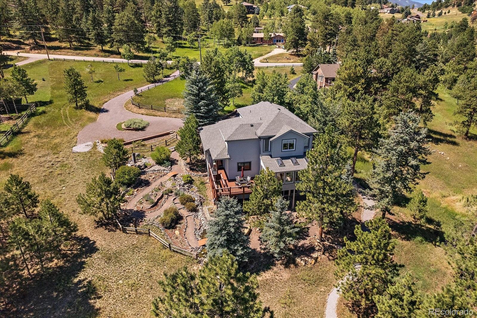 31518 Niakwa Road Evergreen, CO 80439 - Photo 34 of 48 an aerial view of a house with a lake view