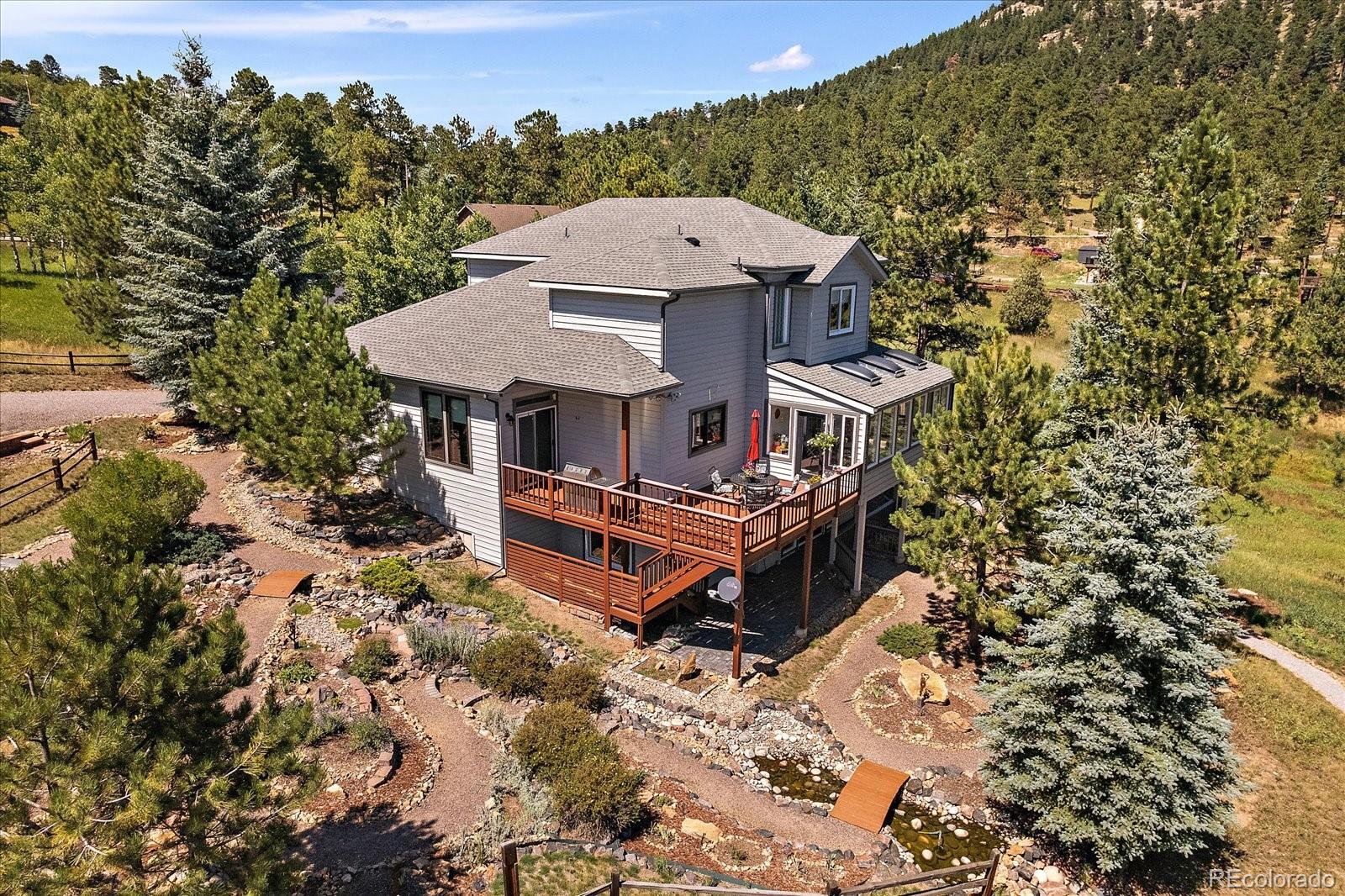 31518 Niakwa Road Evergreen, CO 80439 - Photo 37 of 48 an aerial view of a house with a yard and balcony