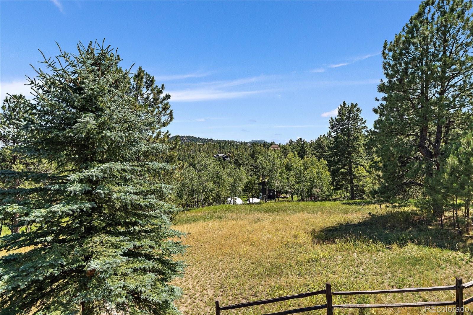 31518 Niakwa Road Evergreen, CO 80439 - Photo 40 of 48 a view of a lake with a yard
