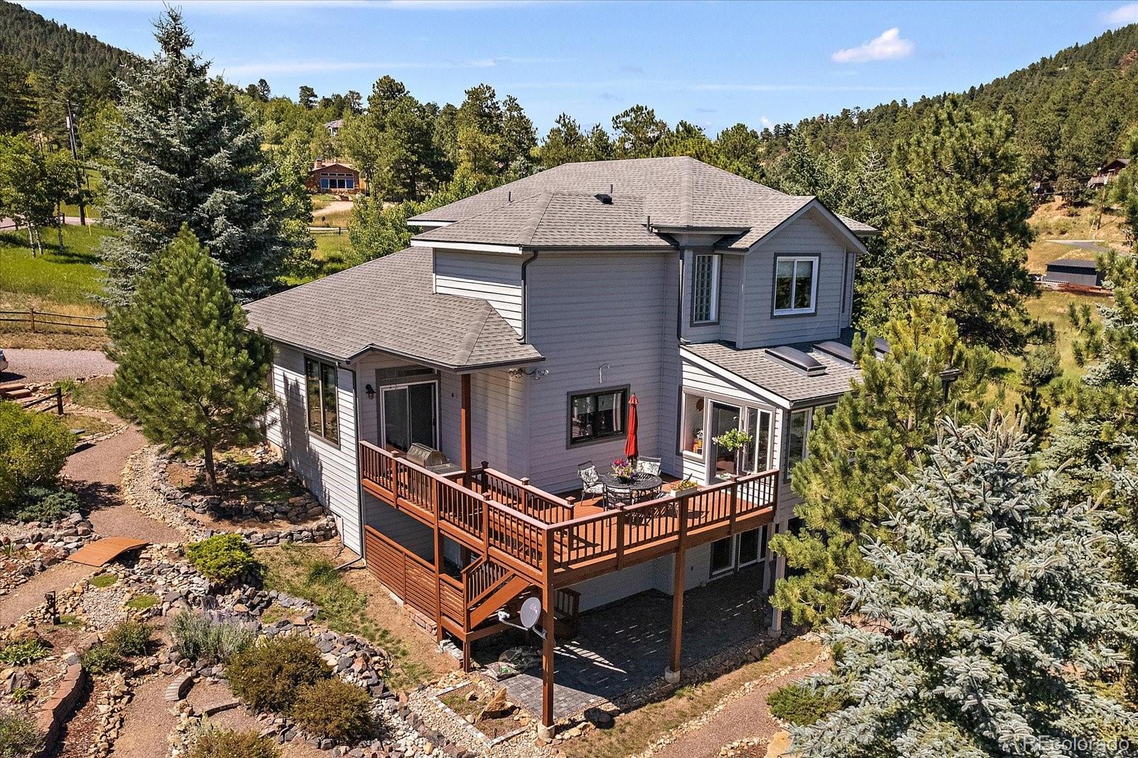 31518 Niakwa Road Evergreen, CO 80439 - Photo 6 of 48 a aerial view of a house with a yard and balcony