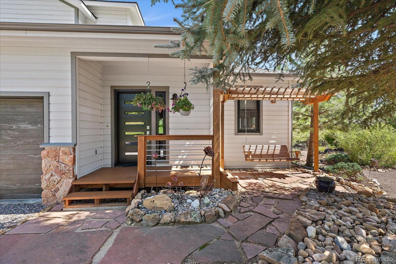 31518 Niakwa Road Evergreen, CO 80439 - Photo 8 of 48 a front view of a house with outdoor space