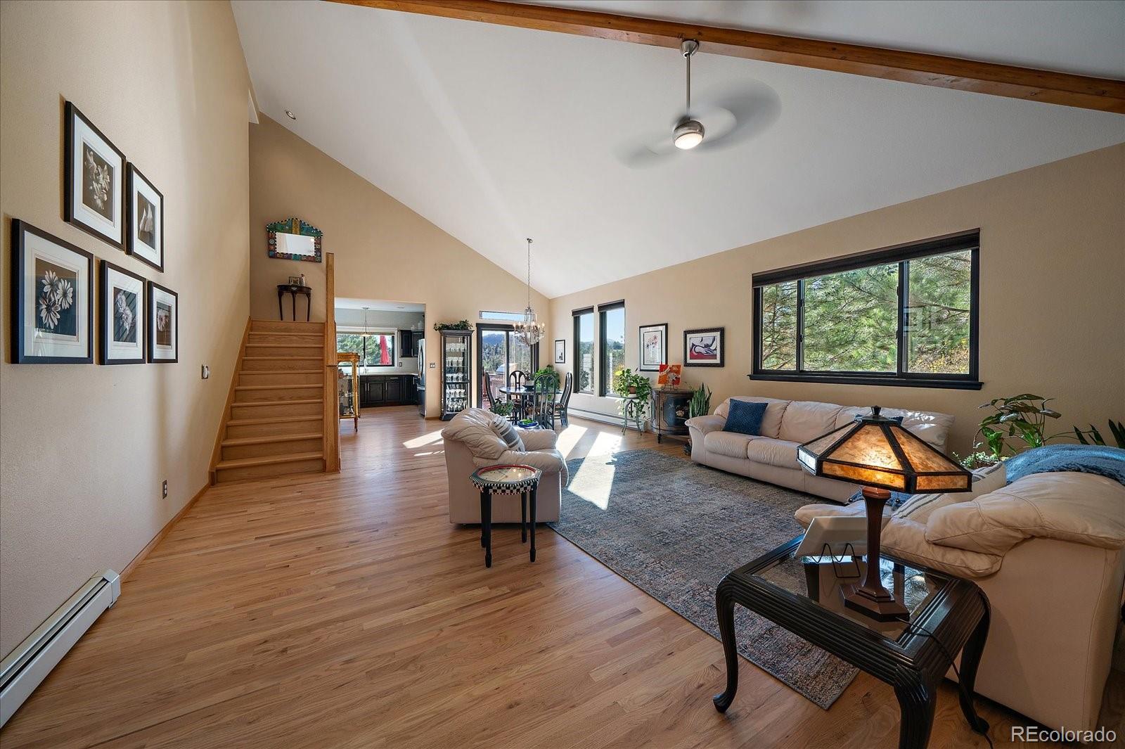 31518 Niakwa Road Evergreen, CO 80439 - Photo 9 of 48 a living room with furniture a rug and a window