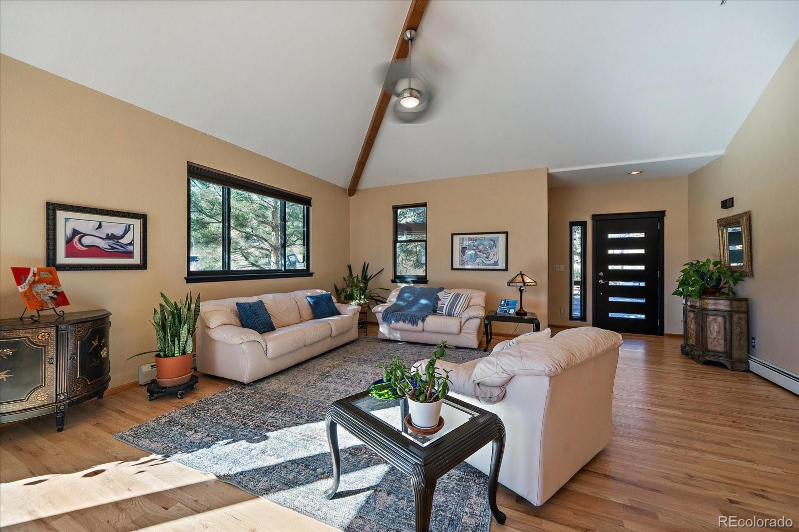 31518 Niakwa Road Evergreen, CO 80439 - Photo 10 of 48 a living room with furniture and a flat screen tv