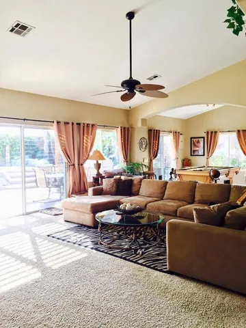 a living room with furniture and a large window