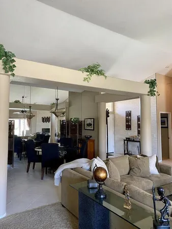 a living room with furniture and kitchen view