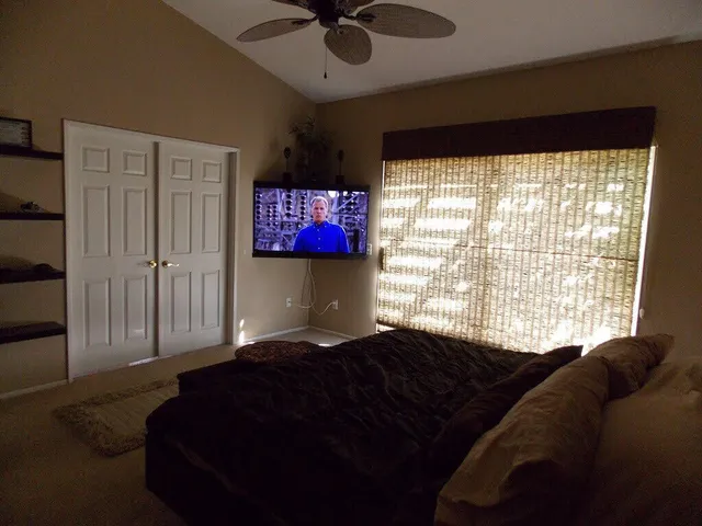 a bedroom with a bed dresser and a window