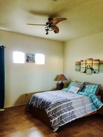 a bedroom with a large bed and a chandelier