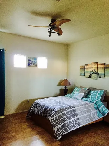a bedroom with a large bed and a chandelier