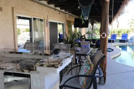 a view of a dinning table and chairs in the patio