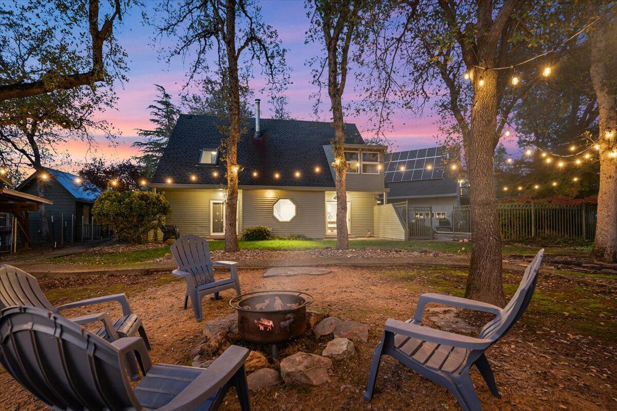 15745 Montgomery Ranch Road Redding, CA 96001 - Photo 4 of 33 a view of a backyard with table and chairs with wooden fence and plants