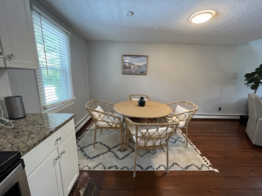 12 State Road, Unit 2E Plymouth, MA 02360 - Photo 4 of 28 a dining room with furniture and wooden floor