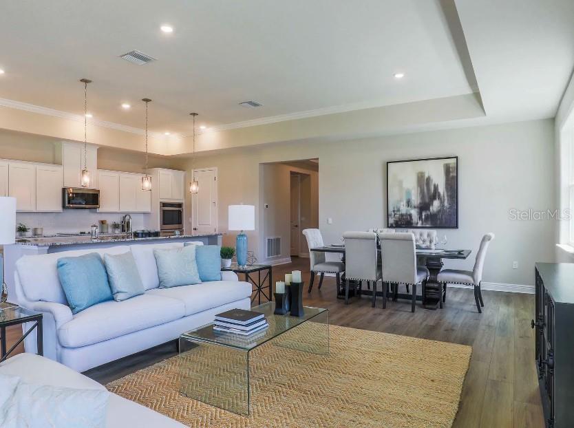 4021 Maggie Loop Lakeland, FL 33813 - Photo 11 of 29 a living room with lots of furniture and wooden floor