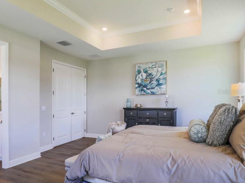 4021 Maggie Loop Lakeland, FL 33813 - Photo 14 of 29 a bedroom with a bed and wooden floor