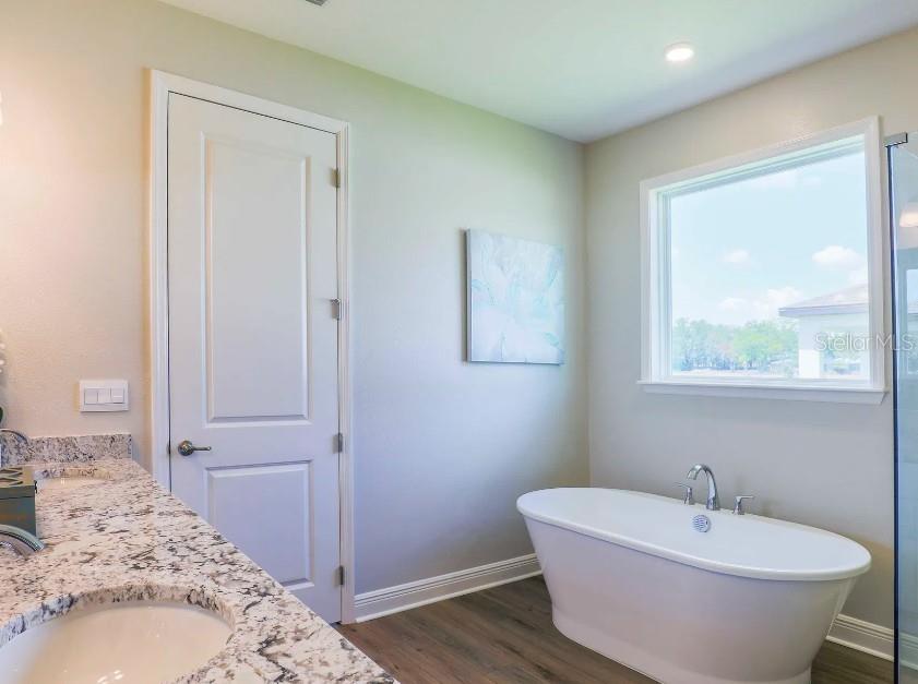4021 Maggie Loop Lakeland, FL 33813 - Photo 17 of 29 a bathroom with a bathtub and shower