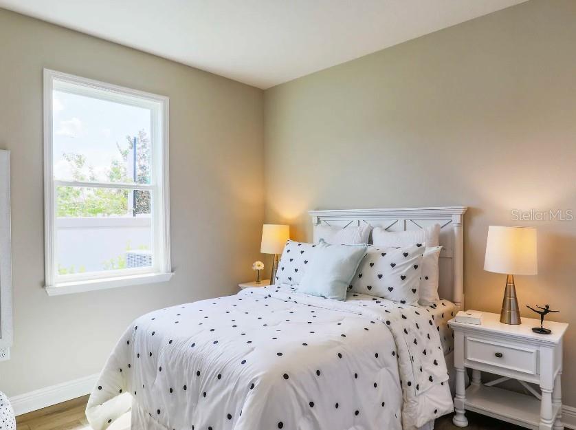4021 Maggie Loop Lakeland, FL 33813 - Photo 19 of 29 a bedroom with a bed and a window
