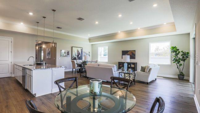 4021 Maggie Loop Lakeland, FL 33813 - Photo 6 of 29 a living room with furniture kitchen view and a wooden floor