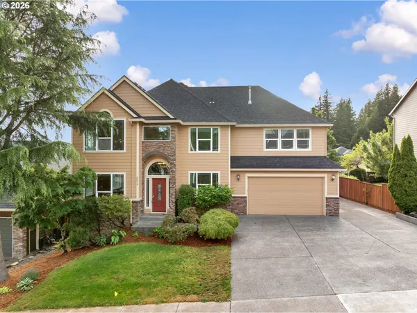a front view of a house with a yard and garage