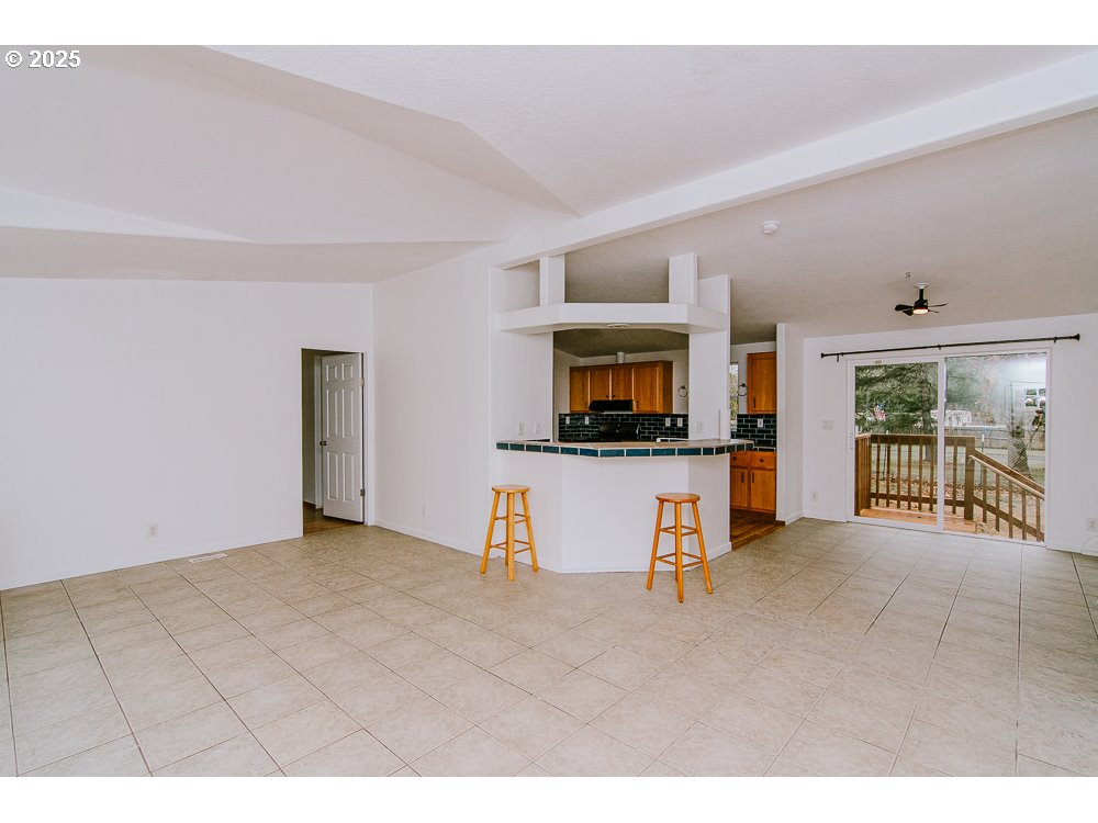 88247 Ellmaker Road Veneta, OR 97487 - Photo 16 of 47 a living room with furniture and a flat screen tv